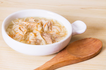 Homemade simple soup in white mug