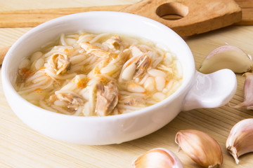 Homemade simple soup in white mug
