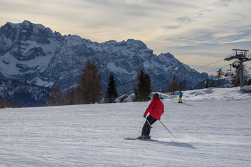 ski slopes with skiers. Trentino, Italy