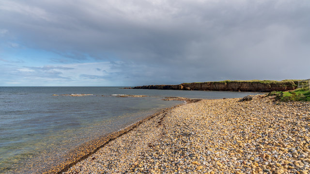 North Sea coast in Benthall, Northumberland, England, UK - looking at Beadnell Point