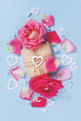 Spring composition with roses, petals, hearts and gift box