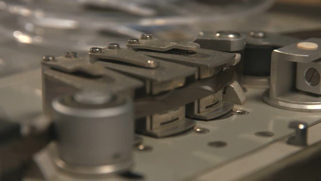 Close up of tape rolling in Nagra old tape recorder