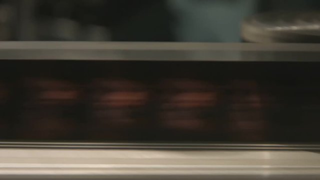 Film close up rolling to end in old film editing equipment