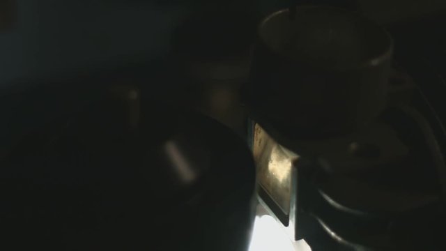 Lamp close up in old film editing equipment rolling to end reel