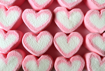 Top View of Lined Up Pastel Pink and White Heart Shaped Marshmallow Candies for Background, Banner, Pattern 