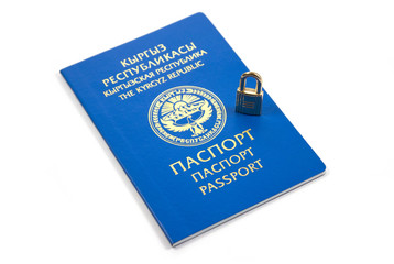 Blue passport of Kyrgyz Republic with lock on a white background, close-up. isolated