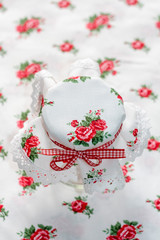 Obraz na płótnie Canvas Decorative handmade textile jar cover with gingham red ribbon