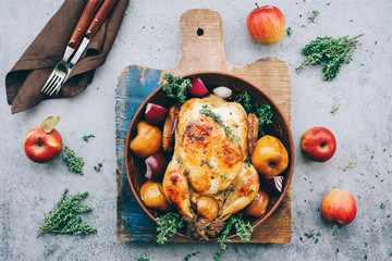 Roasted chicken with apples, thyme and onions. Festive home food concept