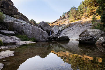 small rapid waterfalls created by a river when passing between stones