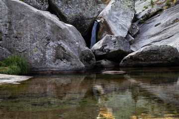 small rapid waterfalls created by a river when passing between stones