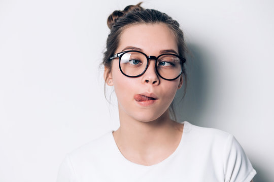 Close up indoor fashion lifestyle portrait of cool pretty young brunette girl, amazing. making crazy funny grimace in glasses