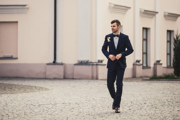 Handsome groom at wedding smiling and waiting for bride man. Happy smiling groom newlywed. Rich man...
