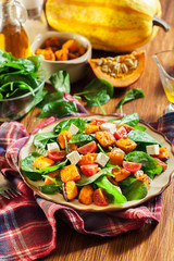 Roasted pumpkin salad with spinach, tomatoes and nuts