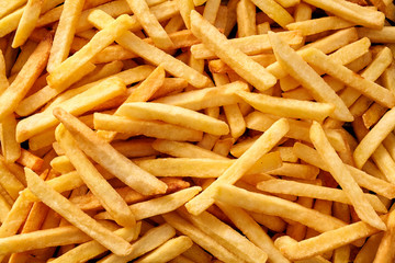 Overhead view of golden deep fried French fries food in full frame closeup. - 242961202
