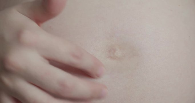 Pregnant Woman Strokes Tummy