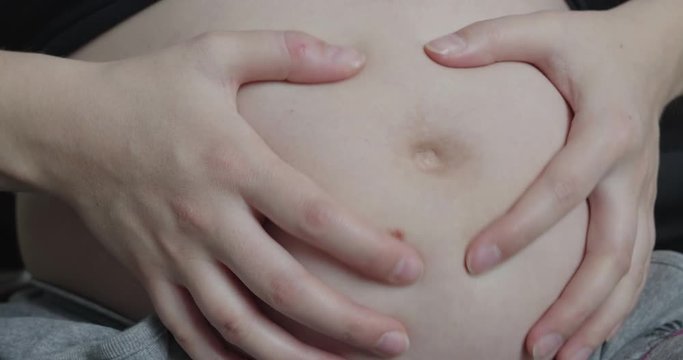 Pregnant Woman Strokes Tummy