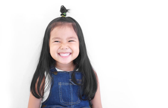 Asian child cute or kid girl and kindergarten student happy smile white teeth and laugh thinking for new idea with wear dungarees jean at dental or pre school on white background with space isolated
