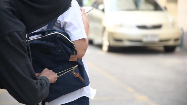 4K Woman on city street is unaware that her purse has been stolen by crafty pickpocket