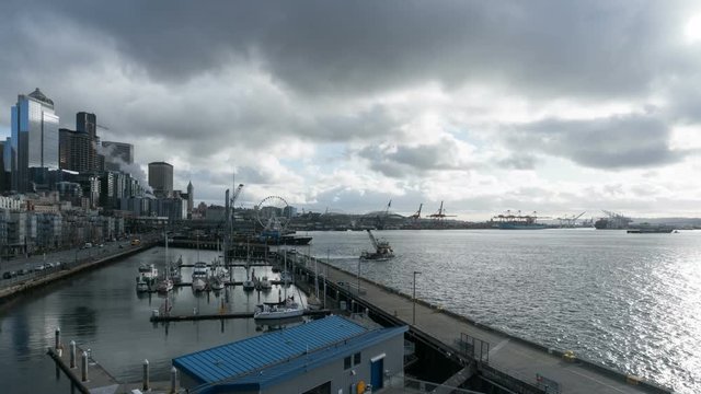 Time lapse of moving dark clouds and stormy sky over Seattle Washington downtown city skyline along Pier 66 and Puget Sound marina waterfront 4k ultra high definition movie 3840x2160