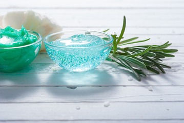 cosmetic cream product samples and lavender leaves on white wooden table background