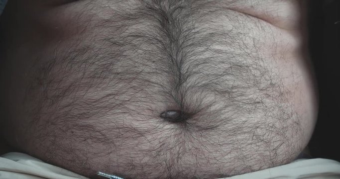 Navel Fluff. fat man check his belly