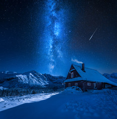 Milky way over mountain cottage in winter, Tatras, Poland