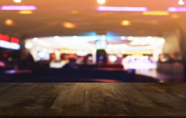 Empty dark wooden table in front of abstract blurred bokeh background of restaurant . can be used for display or montage your products.Mock up for spaceใ