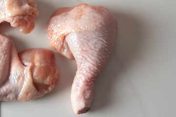 pieces of raw chicken on a white background close-up.