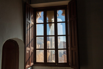 Fototapeta na wymiar Window with views of the castle and a church