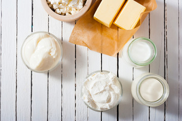 homemade dairy product samples on white wood table background