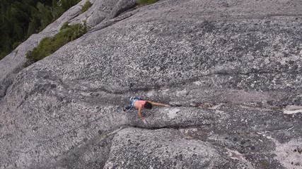 Aerial female climber belaying mountain rock Squamish Canada
