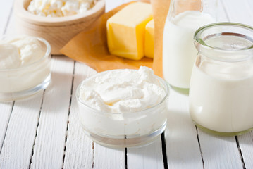Obraz na płótnie Canvas homemade dairy product samples on white wood table background