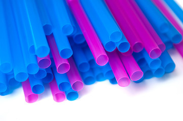 closeup of colorful plastic straws collection on white background