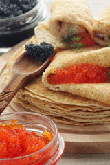 Russian pancakes with red and black caviar