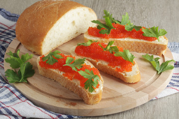Sandwiches with butter and red caviar