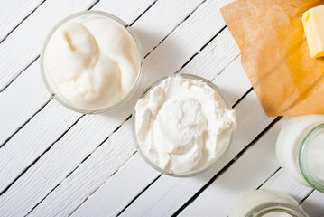 yogurt and creme fraiche on white wooden table background