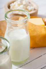 homemade dairy product samples on white wood table background