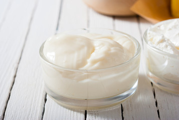 yogurt and creme fraiche on white wooden table background