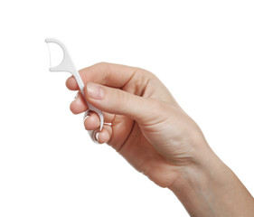 Woman holding dental floss pick on white background. Mouth and teeth care - obrazy, fototapety, plakaty