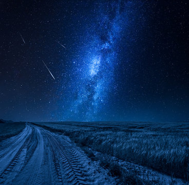 Blue Milky Way Over Field With Country Road At Night