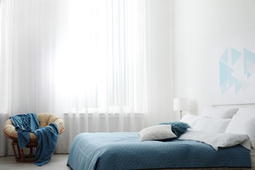 Fototapeta na wymiar Light modern room interior with comfortable bed