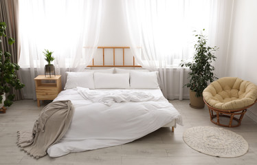 Light modern room interior with comfortable bed
