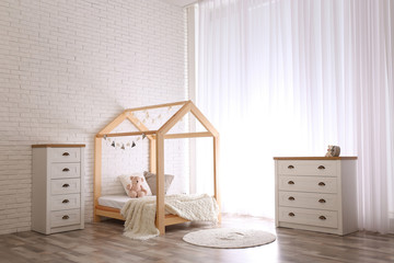 Stylish kid's room interior with cute wooden bed