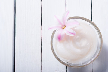 moisturizer with hyacinth on white wood table