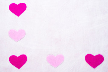 Fototapeta na wymiar Background with hearts made of pink felt