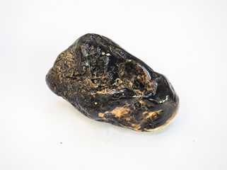 macro precious black jasper nugget on white background