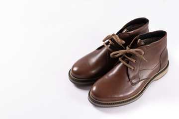 Footwear. Winter leather male shoes on white background. Copy space. Side view.