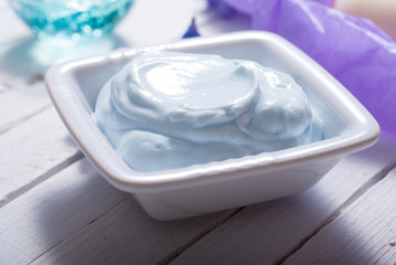 skin care product samples and purple hyacinth flowers on white wooden