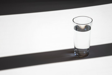 glass of water minimalism concept, shadows and lights elegant rhythm horizontal picture