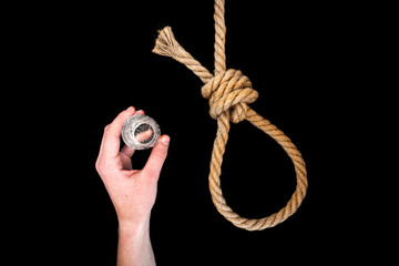 Rope, pills and glass of alcohol (vodka) on black background. Suicide. Running knot. 
